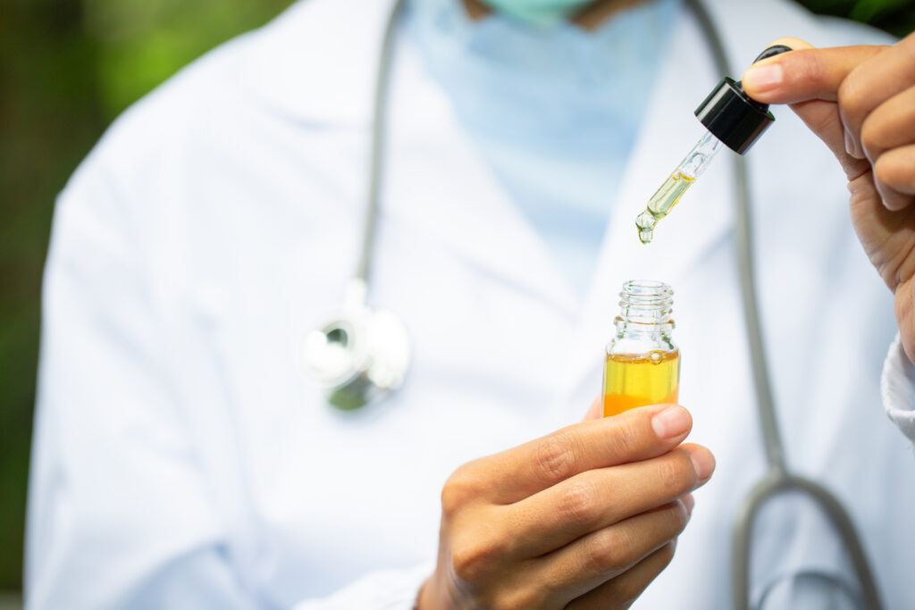 Médico mostra um medicamento em óleo, como o extrato de cannabis.